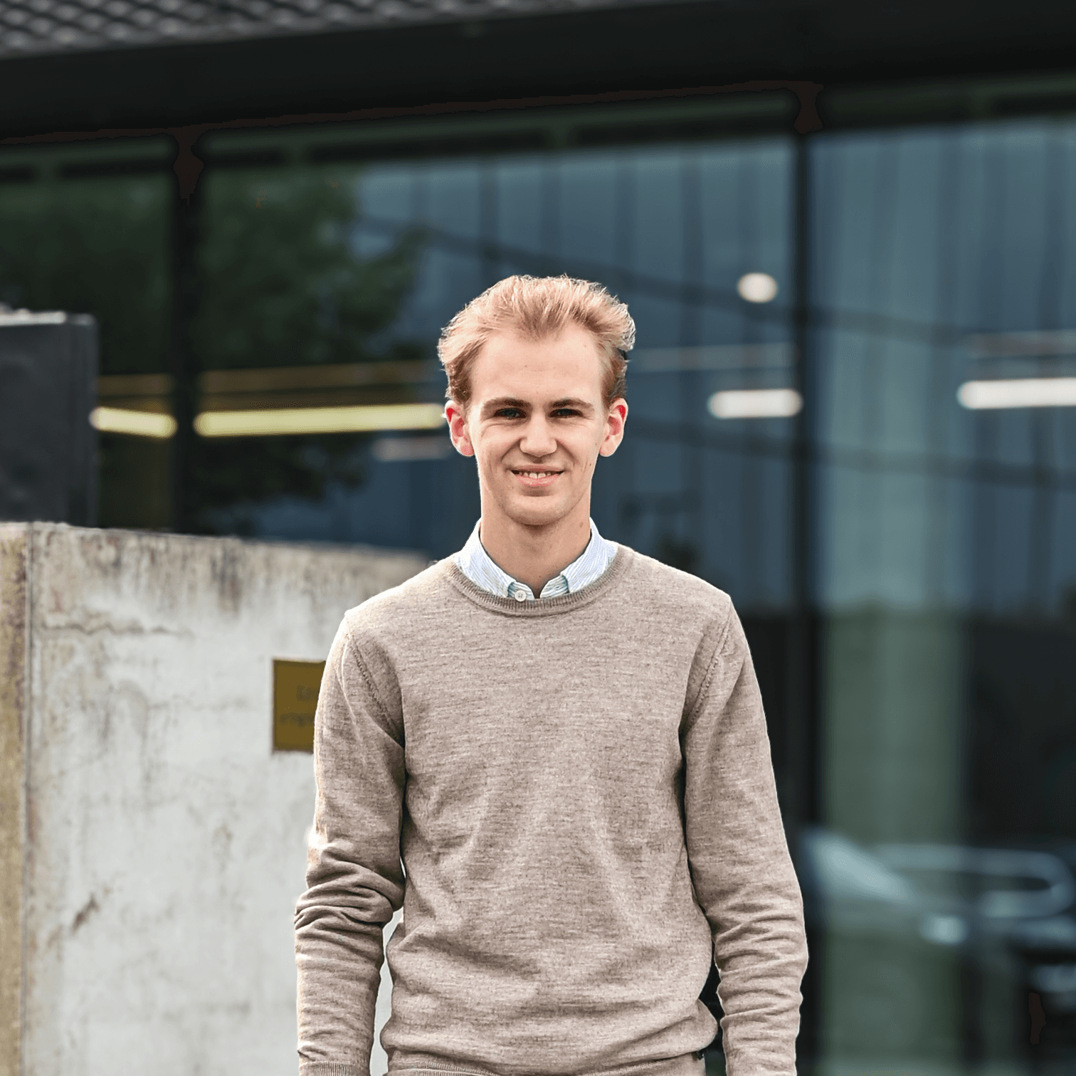 Black leather rounded-md journal with silver steel disc binding resting on wooden shelf with machined steel pen.